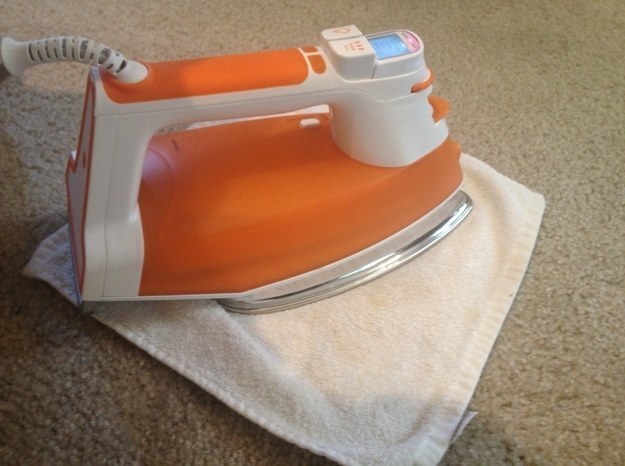 Use an iron and vinegar to get rid of deep set carpet stains.
